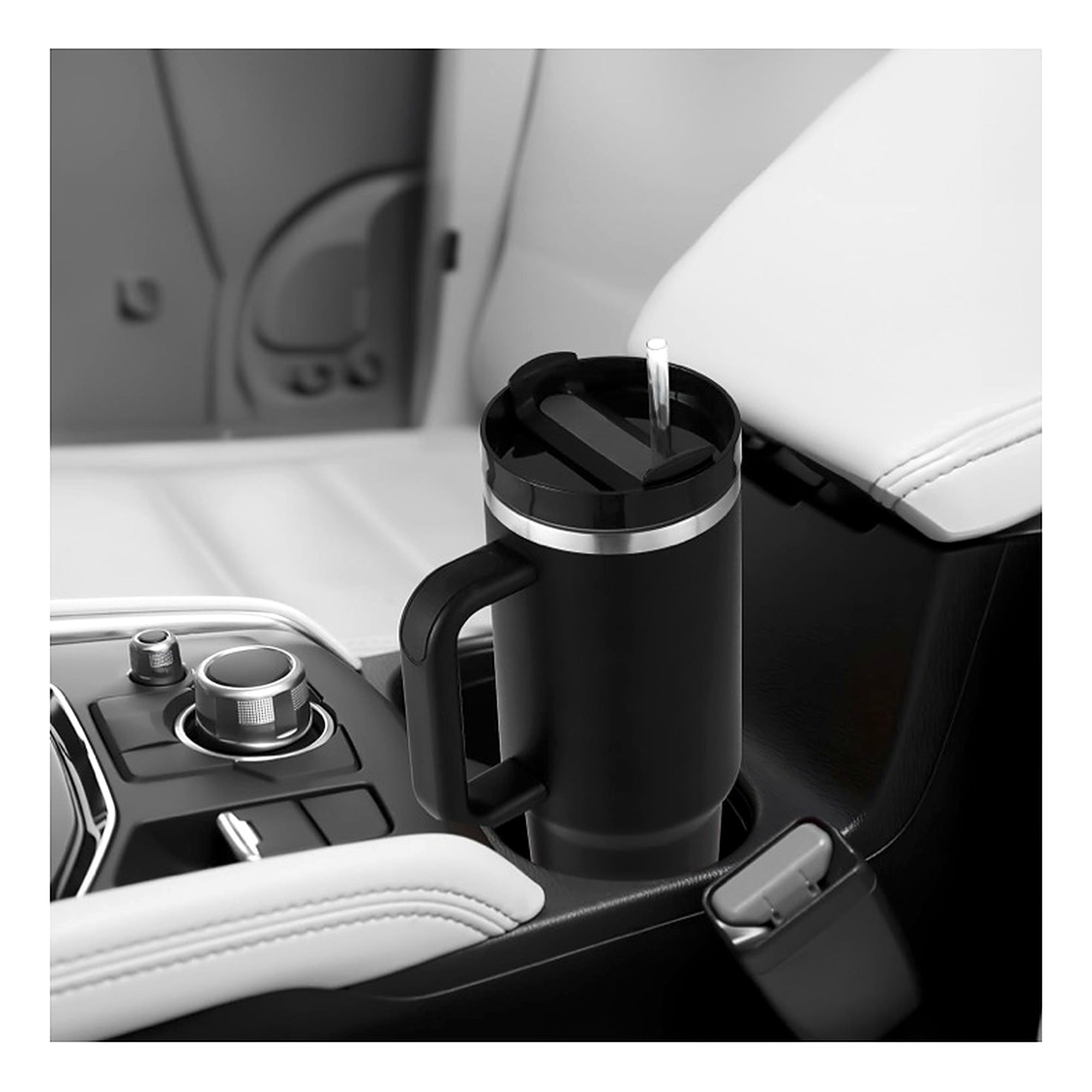 A black insulated travel mug with a handle and lid, shown placed in a car center console cup holder next to the armrest.