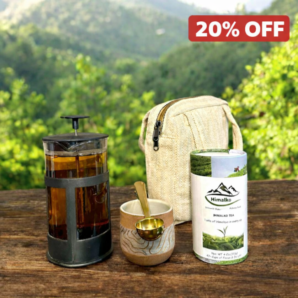 Tea-making set with a French press, tea leaves, and a bag on a wooden table with a scenic background.