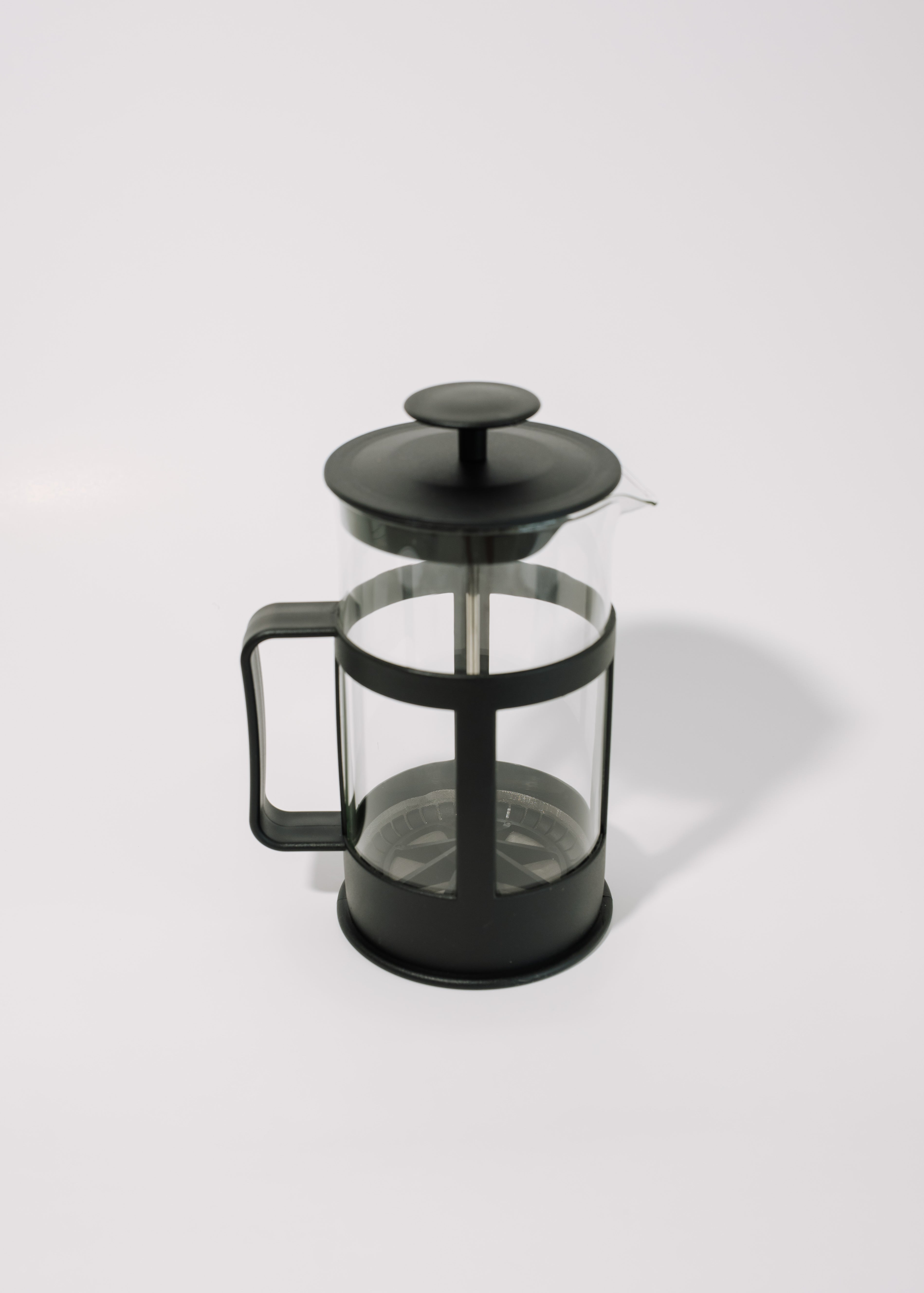 Black French press coffee maker on a white background